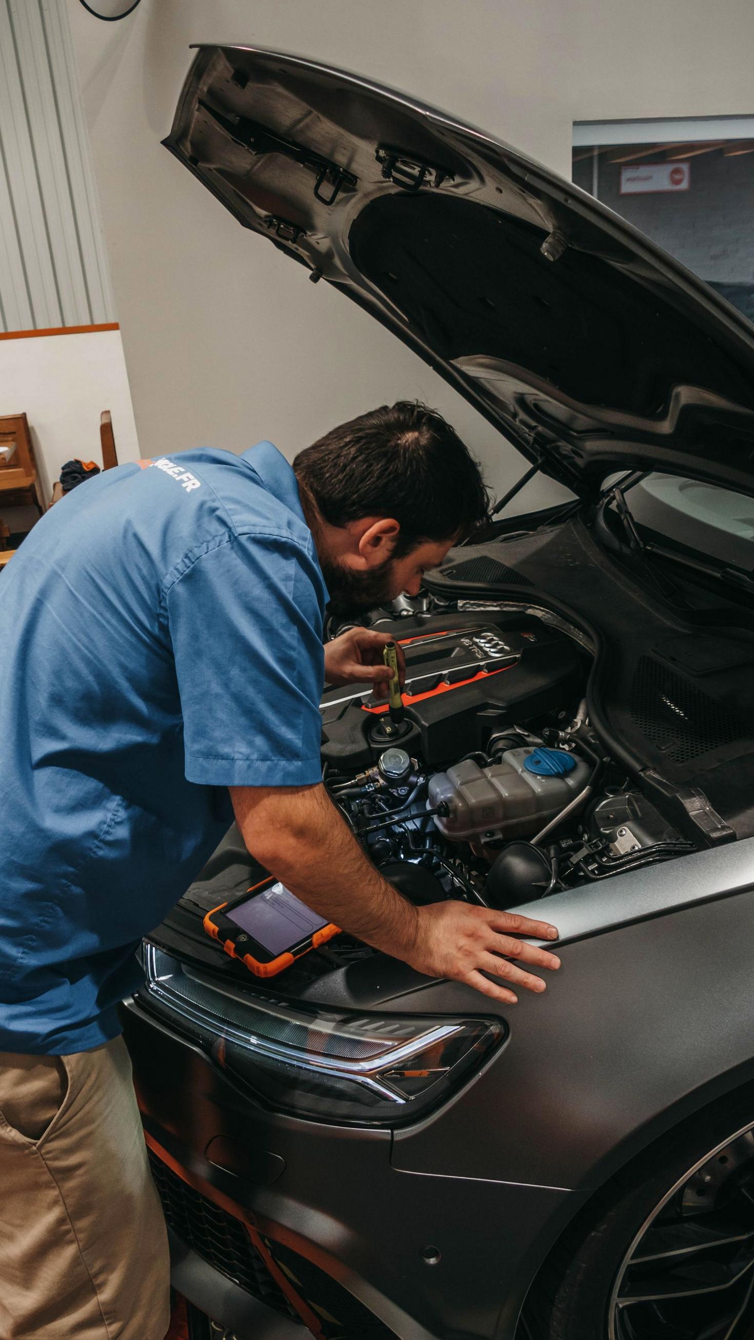 Mechanic examining car engine